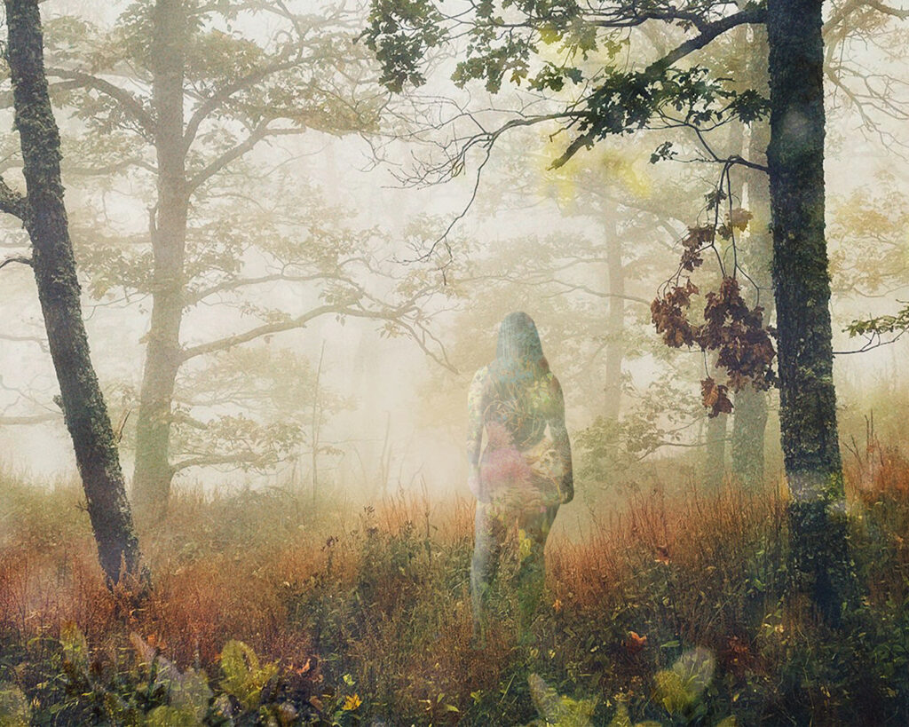 An old Volvo car with a lake and mountains in the background